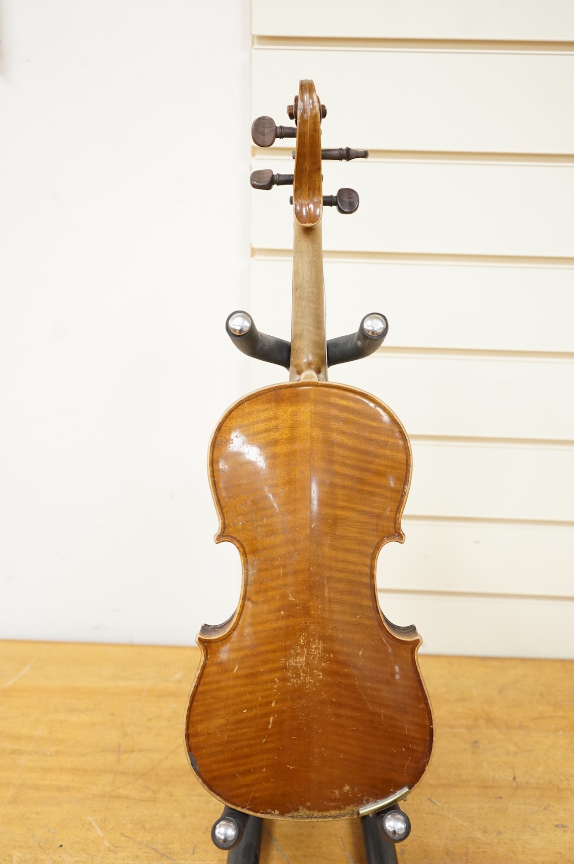 Five cased 20th century violins, including; a German violin, two Czech violins, a three-quarter size violin with a label for Bienfait, and a Romanian quarter size violin, all in cases or the remains of cases.